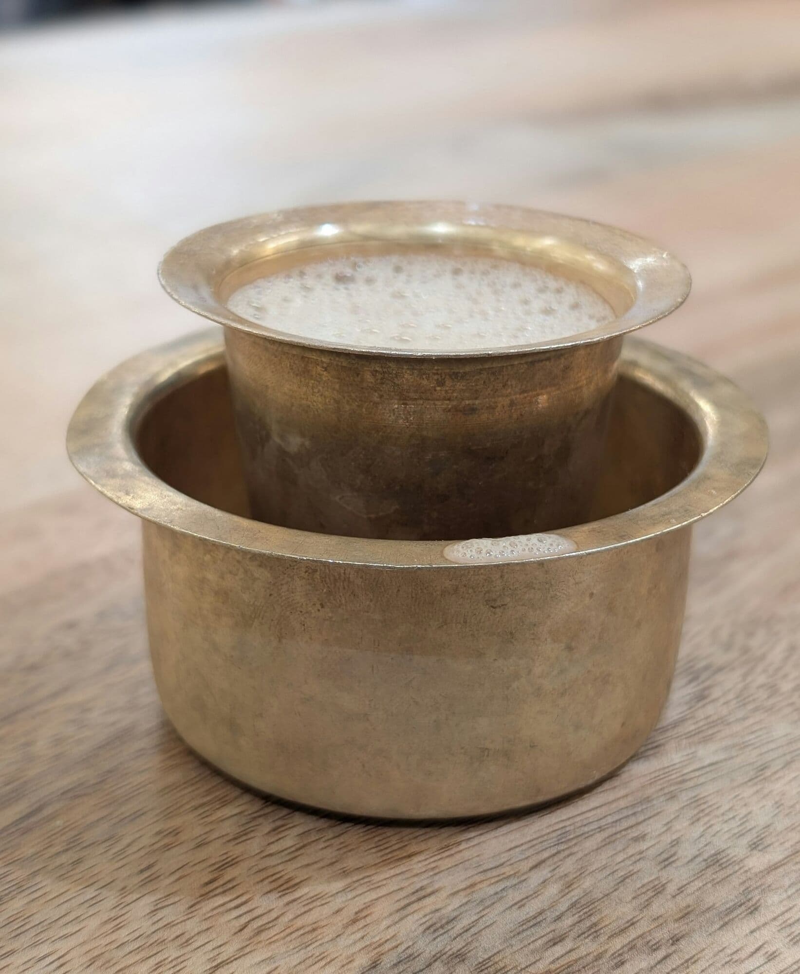 South Indian filter coffee in a brass davara and tumbler